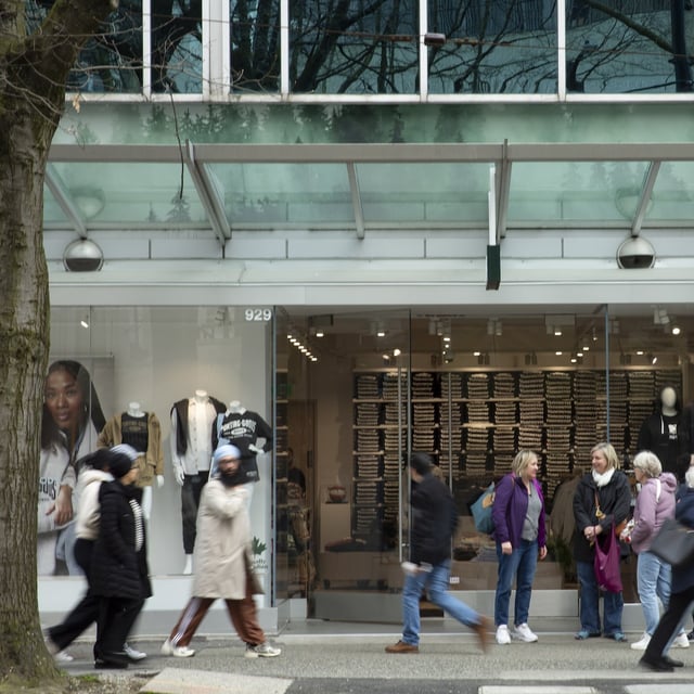 People outside the Roots store on Robson and Burrard in downtown Vancouver on April 1, 2025. The company reported a Q4 loss of $21.7 million as it took a large non-cash impairment charge. [Isabella Falsetti/Globe and Mail]