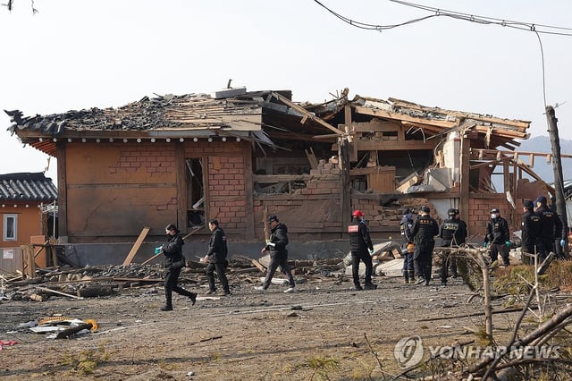 Investigators examine the site of an accidental fighter jet bombing over a village in Pocheon, some 40 kilometers north of Seoul, on March 7, 2025. (Yonhap)
