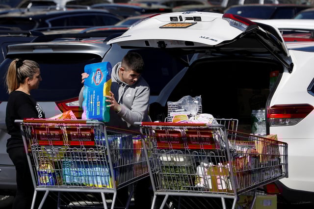 People load Clorox into their car in the Costco parking lot in New York State, in the Brooklyn borough of New York City, New York, U.S., March 2, 2020. REUTERS/Andrew Kelly/File Photo