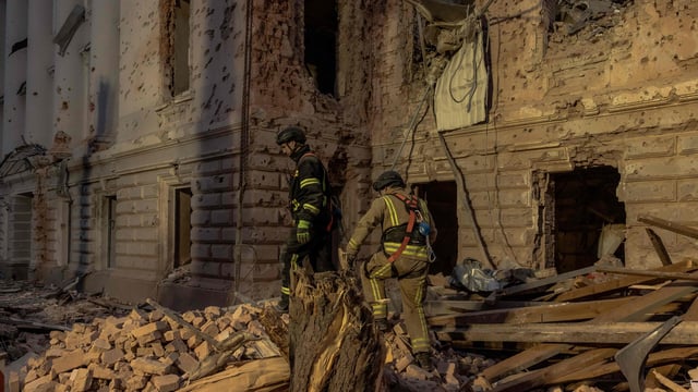 Ukrainian rescuers search rubbles at the site of a missile attack in Sumy, northeastern Ukraine, on April 13, 2025, amid the Russian invasion of Ukraine. 