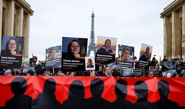 Supporters and relatives of French citizens detained in Iran, Cecile Kohler, Benjamin Briere, Jacques Paris and Fariba Adelkhah, gather in front of the Eiffel Tower during a rally demanding their release, in Paris, France, January 28, 2023. REUTERS/Christian Hartmann/File Photo