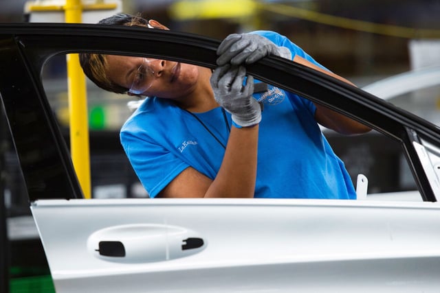 Employees install parts ona door for the Mercedes-Benz C-Class at the Mercedes-Benz US International factory in Vance, Alabama on June 8, 2017. 
President Donald Trump's harsh criticism of Germany's trade practices is sowing concerns in rural, Republican Alabama, where Mercedes-Benz has been an economic engine for two decades.   / AFP PHOTO / Andrew CABALLERO-REYNOLDS / With AFP Story by Luc OLINGA:  Mercedes US home of Alabama shudders at harsh Trump trade talk        (Photo credit should read ANDREW CABALLERO-REYNOLDS/AFP via Getty Images)