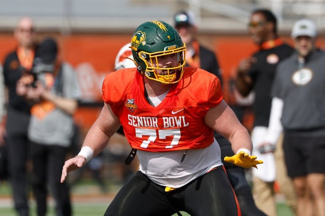 National team offensive lineman Grey Zabel of North Dakota State (77) runs through drills during practice for the Senior Bowl NCAA college football game, Wednesday, Jan. 29, 2025, in Mobile, Ala. (AP Photo/Butch Dill)