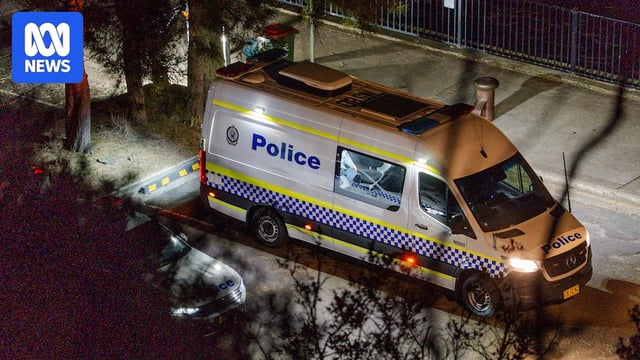 a nsw police van next to the water during the search for a driver in the parramatta river