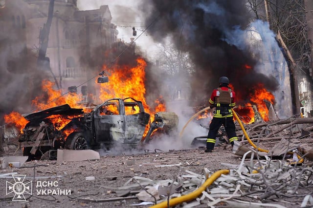 A firefighter battles a blaze Sunday at the site of a missile attack in Sumy, northeastern Ukraine.