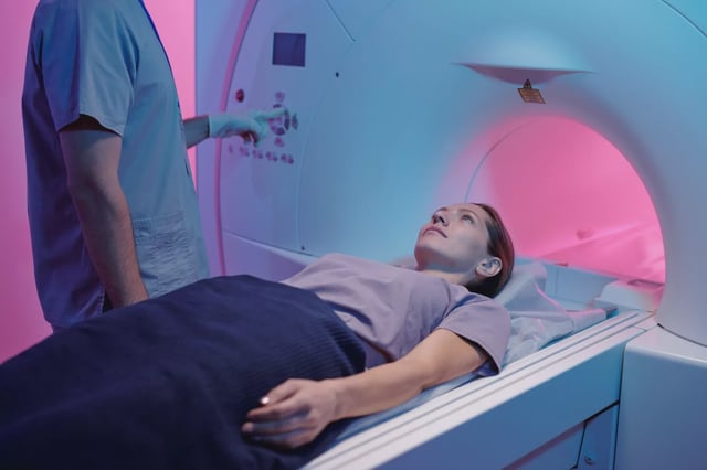Young woman on medical table moving into mri scan machine