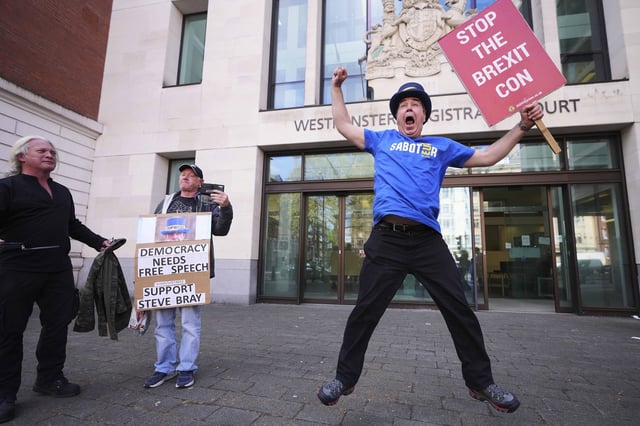 Anti-Brexit campaigner Steve Bray celebrates as he leaves Westminster Magistrates Court in London, Monday, April 14, 2025, after he has been found not guilty to failing without reasonable excuse to comply with a direction given under the Police Reform and Social Responsibility Act 2011. (AP Photo/Kirsty Wigglesworth)
