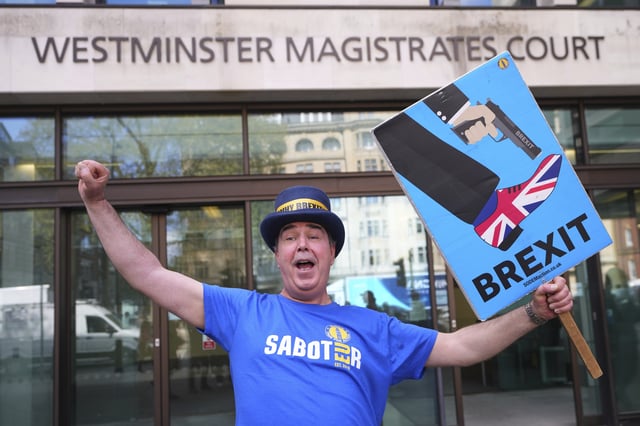 Anti-Brexit campaigner Steve Bray celebrates as he leaves Westminster Magistrates Court in London, Monday, April 14, 2025, after he has been found not guilty to failing without reasonable excuse to comply with a direction given under the Police Reform and Social Responsibility Act 2011. (AP Photo/Kirsty Wigglesworth)