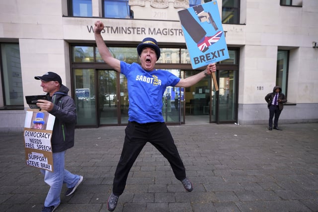 Anti-Brexit campaigner Steve Bray celebrates as he leaves Westminster Magistrates Court in London, Monday, April 14, 2025, after he has been found not guilty to failing without reasonable excuse to comply with a direction given under the Police Reform and Social Responsibility Act 2011. (AP Photo/Kirsty Wigglesworth)