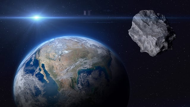 Planet Earth and big asteroid in the space.
