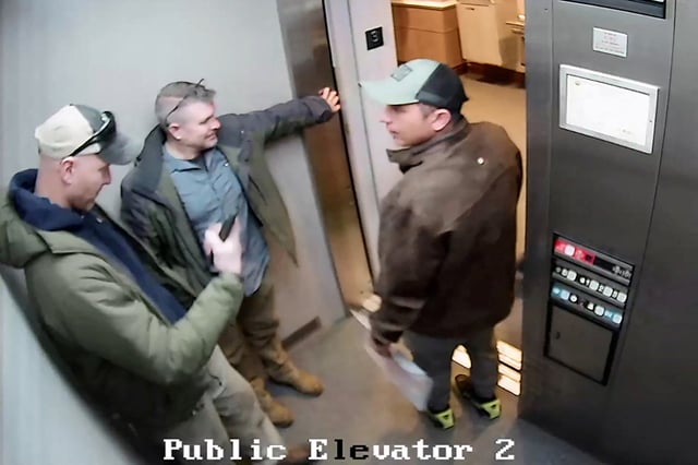 Federal agents speak with Arnuel Marquez Colmenarez, a 33 year old Venezuelan man inside the elevator of a New Hampshire courthouse before his arrest, in a still image from surveillance camera video taken in Nashua, New Hampshire, U.S. February 20, 2025.   New Hampshire Judicial Branch/Handout via REUTERS.