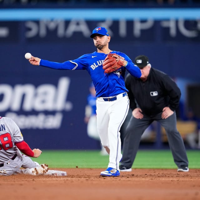 TORONTO, ON - APRIL 14: Andres Gimenez #0 of the Toronto Blue Jays turns a double play over Matt Olson #28 of the Atlanta Braves during the second inning in their MLB game at the Rogers Centre on April 14, 2025 in Toronto, Ontario, Canada. (Photo by Mark Blinch/Getty Images)