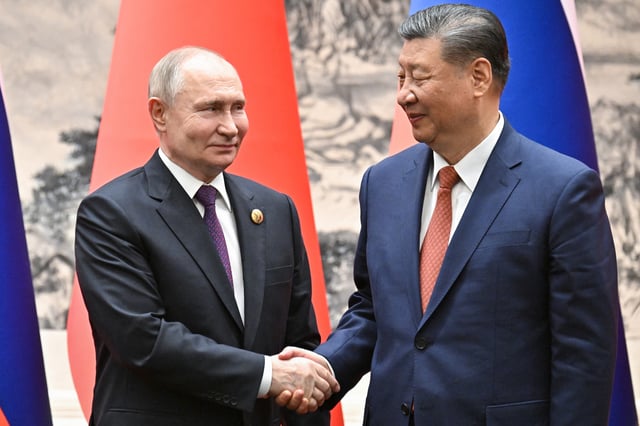 Russia&#39;s President Vladimir Putin and China&#39;s President Xi Jinping shake hands during a signing ceremony following their talks in Beijing on May 16, 2024.