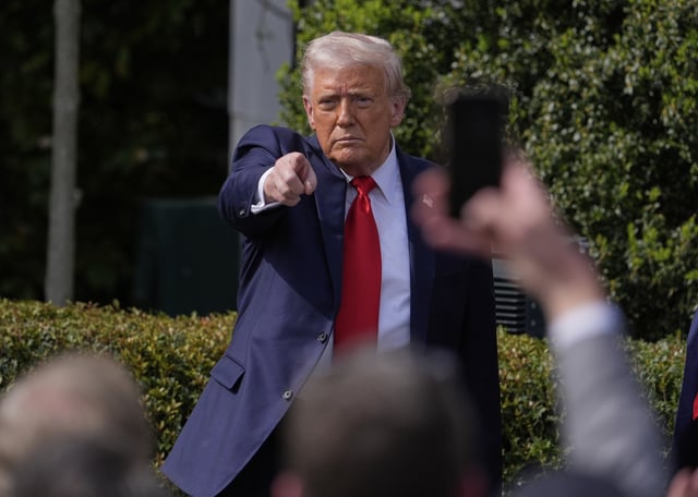 President Donald Trump gestures to the crowd as he departs after welcoming the 2025 College Football National Champions, the Ohio State University football team, during an event on the South Lawn of the White House, Monday, April 14, 2025, in Washington. (AP Photo/Manuel Balce Ceneta)