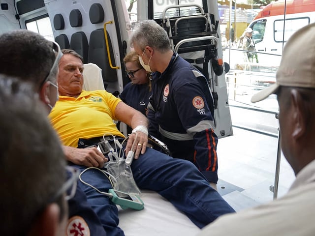 Former Brazilian president Jair Bolsonaro arrives by ambulance at the Rio Grande Hospital in Natal, Rio Grande do Norte state, Brazil on April 11, 2025. Brazilian former president Jair Bolsonaro, who was stabbed at an election rally in 2018, was rushed to hospital by helicopter on April 11, 2025, with "severe pain" in his abdomen, a party spokesman said. Bolsonaro, 70, was at a party event in the northeastern state of Rio Grande do Norte when he fell unwell "linked to the 2018 stabbing," the spokesman told AFP. (Photo by MAGNUS NASCIMENTO / AFP)