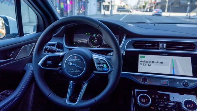 A Waymo autonomous self-driving Jaguar taxi drives in Los Angeles, California.