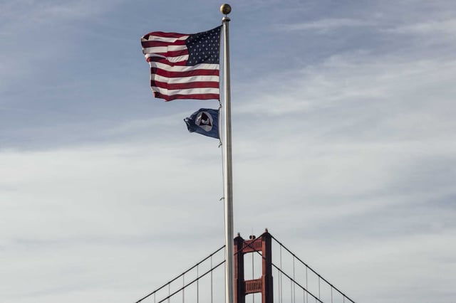 A flag of the National Oceanic and Atmospheric Administration (NOAA) is seen beneath a U.S. flag at its Greater Farallones National Marine Sanctuary office at the Presidio in San Francisco on a February day. The Trump administration is once again taking aim at the agency in a far-reaching budget proposal that if approved would gut climate and weather research. 