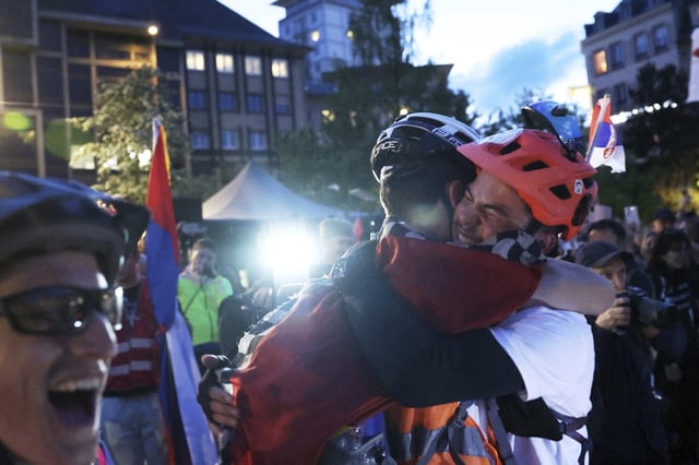Protesting Serbian university students who rode bicycles from Novi Sad, Serbia, react after they arrive in the heart of the European Union to seek support, Tuesday, April 15, 2025 in Strasbourg, eastern France. (AP Photo/Antonin Utz)