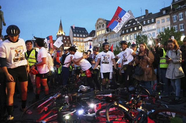 Protesting Serbian university students who rode bicycles from Novi Sad, Serbia, react after they arrive in the heart of the European Union to seek support, Tuesday, April 15, 2025 in Strasbourg, eastern France. (AP Photo/Antonin Utz)