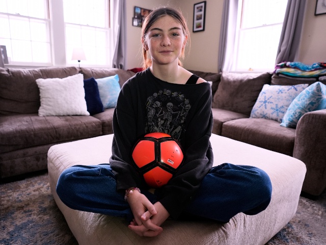 Parker Tirrell, a transgender athlete who plays on his high school's girls soccer team, poses in the living room of hisfamily home, Friday, March 7, 2025, in Plymouth, N.H. (AP Photo/Charles Krupa)