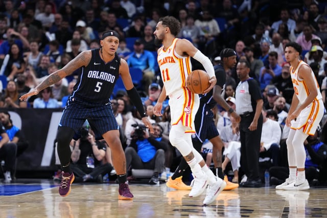 Trae Young #11 of the Atlanta Hawks dribbles the ball against Paolo Banchero #5 of the Orlando Magic during the fourth quarter at Kia Center on April 08, 2025 in Orlando, Florida.