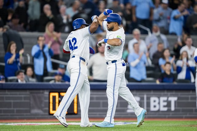 Toronto Blue Jays outfielder Anthony Santander (right) celebrates hitting a home run with first base Vladimir Guerrero Jr. against the Atlanta Braves during fifth inning MLB baseball action in Toronto on Tuesday, April 15, 2025 THE CANADIAN PRESS/Thomas Skrlj