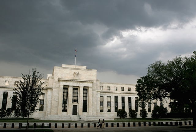 Early summer storm clouds gather over the U.S. Federal Reserve Building before an evening thunderstorm in Washington June 9, 2006. REUTERS/Jim Bourg/File Photo