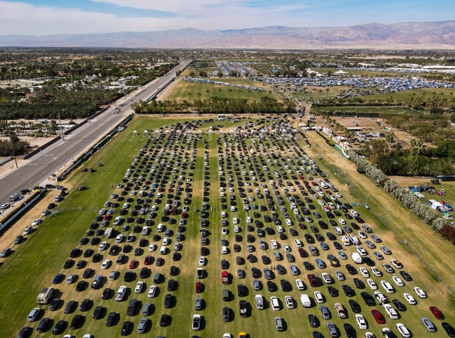 Hundreds of cars wait in a series of lines to get through a security screening area before arriving at the car camping grounds at the Coachella Valley Music and Arts Festival in Indio, Calif., Thursday, April 10, 2025.