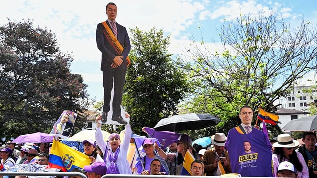 Supporters hold a lifesize cut out of Ecuador's President reelect Daniel Noboa.