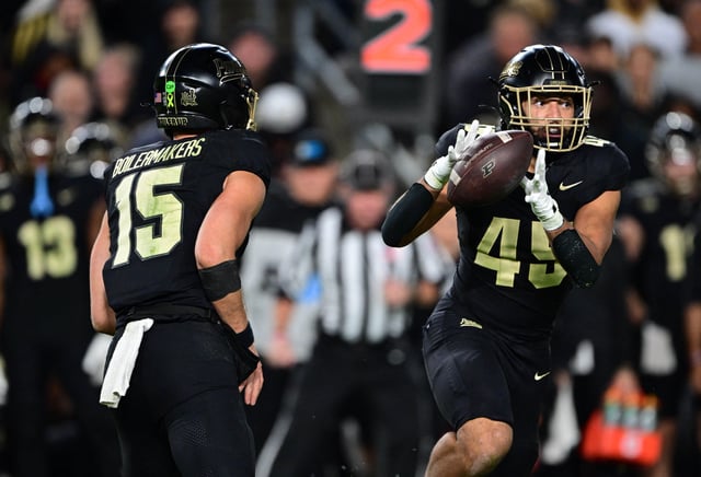 Oct 18, 2024; West Lafayette, Indiana, USA; Purdue Boilermakers quarterback Ryan Browne (15) pitches the ball to running back Devin Mockobee (45) during the second half against the Oregon Ducks at Ross-Ade Stadium. Mandatory Credit: Marc Lebryk-Imagn Images