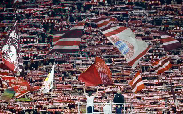 Soccer Football - Champions League - Round of 16 - First Leg - Bayern Munich v Bayer Leverkusen - Allianz Arena, Munich, Germany - March 5, 2025  Bayern Munich fans with flags in the stands REUTERS/Heiko Becker/File Photo