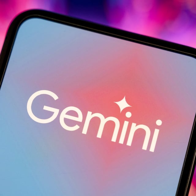 Google Gemini logo shown on a smartphone on a pink background.