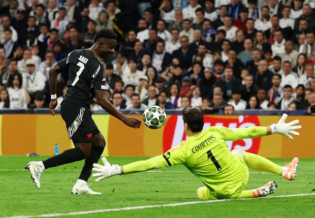 Soccer Football - Champions League - Quarter Final - Second Leg - Real Madrid v Arsenal - Santiago Bernabeu, Madrid, Spain - April 16, 2025 Arsenal's Bukayo Saka scores their first goal Action Images via Reuters/Lee Smith/ File Photo