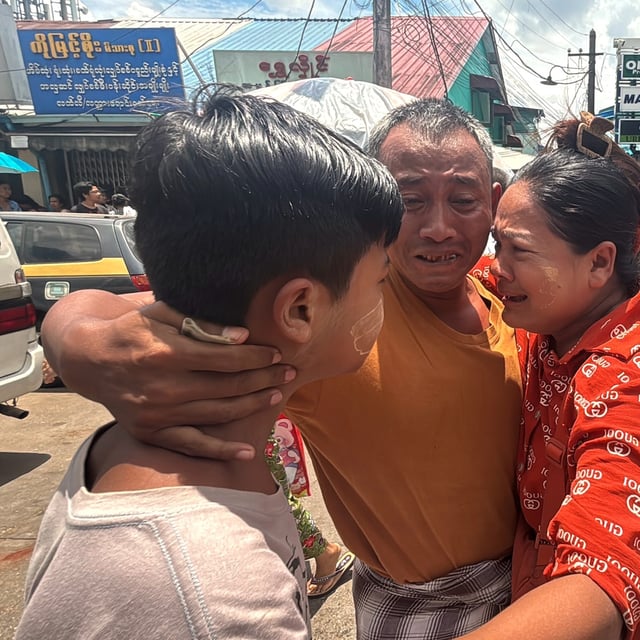 A released prisoner, center, is welcomed by family members outside the main gate of Insein prison as the head of Myanmar’s military government granted amnesty to thousands of prisoners to mark the country's traditional New Year Thursday, April 17, 2025, in Yangon, Myanmar. (AP Photo/Thein Zaw)
