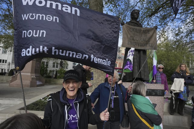 Women's rights activists hold placards outside the Supreme Court to challenge gender recognition laws, in London, Wednesday, April 16, 2025. (AP Photo/Kin Cheung)