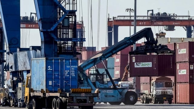 A crane loads shipping containers on a truck at the Deendayal Port Authority (DPA) in Kandla in Gujarat on April 5 (AFP FILE PHOTO)