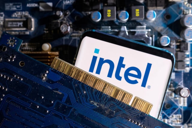 A smartphone with a displayed Intel logo is placed on a computer motherboard in this illustration taken March 6, 2023. REUTERS/Dado Ruvic/Illustration/File Photo