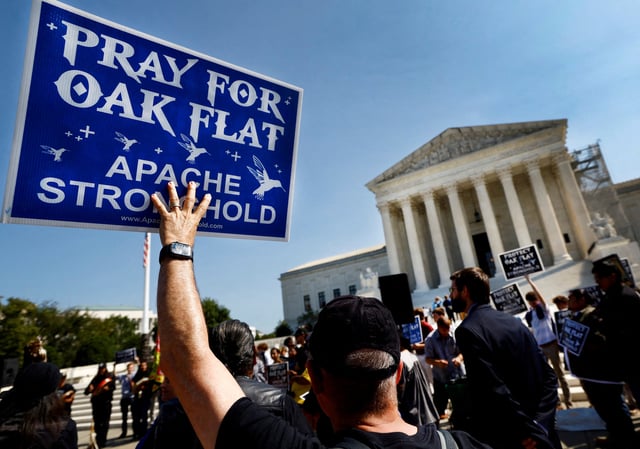 Members of the Native American group Apache Stronghold hold protest cards ahead of formally asking the U.S. Supreme Court to overturn an earlier ruling allowing Rio Tinto to develop the Resolution Copper mine in Arizona, outside the court in Washington, U.S., September 11, 2024. REUTERS/Piroschka van de Wouw/File Photo