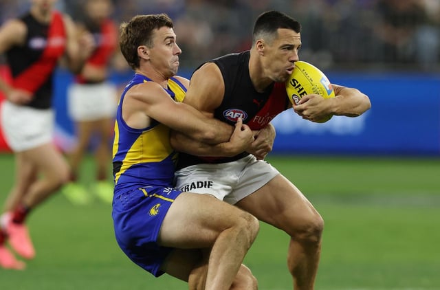 Jamie Cripps tackles Dylan Shiel.