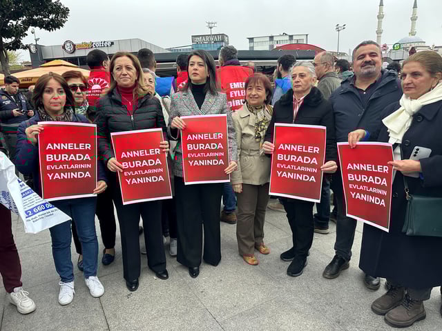 Turkish protesters hold signs reading, "The moms are here standing by their kids," in Istanbul on April 18.