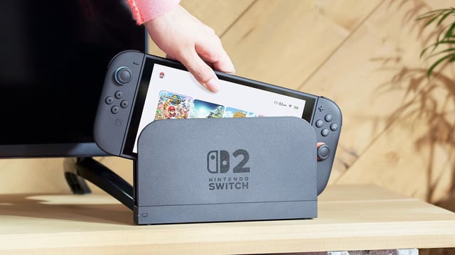 A Switch 2 being removed from its dock.
