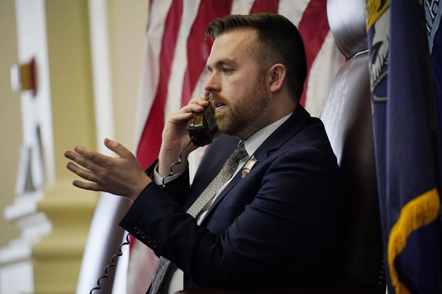FILE - House speaker Ryan Fecteau, D-Biddeford, discusses legislative business on the phone, April 25, 2022, at the State House in Augusta, Maine. (AP Photo/Robert F. Bukaty, File)