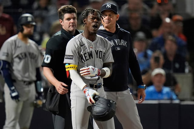 New York Yankees’ Jazz Chisholm Jr., center, reacts after getting called out on strikes by home plate umpire John Bacon, left, during the seventh inning of a baseball game against the Tampa Bay Rays Thursday, April 17, 2025, in Tampa, Fla. (AP Photo/Chris O’Meara)