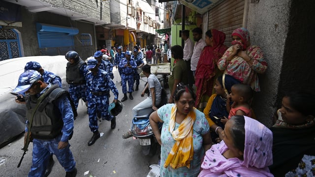 Security personnel in Seelampur as locals protest against the murder of a 17-year-old boy in New Delhi, India, on Friday, April 18, 2025.