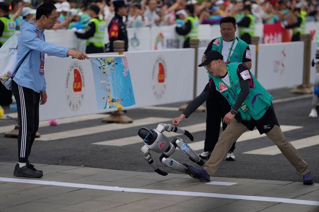 A robot loses control at the start of what is billed as the world's first robot half marathon in Beijing, Chaina, on April 19, 2025.