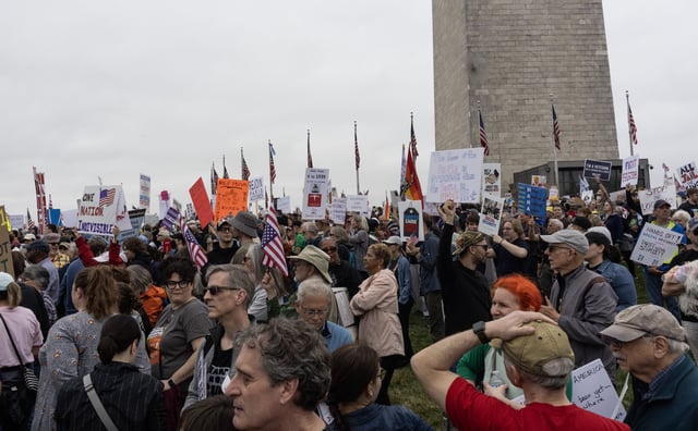 Demonstrators join the Hands Off march to protest DOGE cuts by Elon Musk and President Trump, April 5, 2025, in Washington, D.C.  Further protests are planned for April 19.