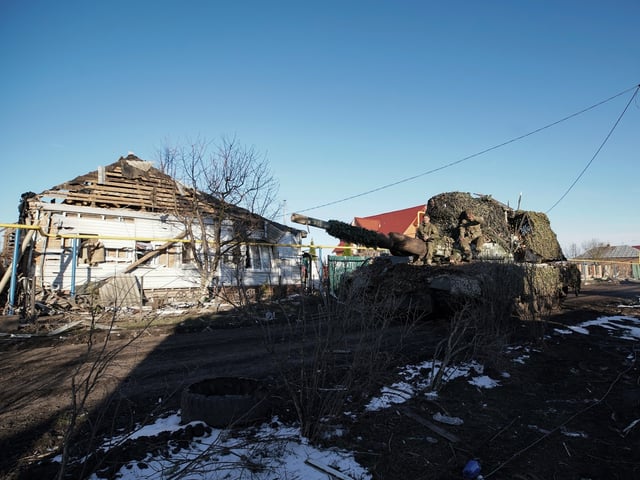 Russian soldiers ride atop a military vehicle past destroyed houses in the village of Kazachya Loknya, which was previously held by Ukrainian troops and recently retaken by Russia's armed forces, in the Sudzha district of the Kursk region on March 18, 2025, amid the ongoing Russian-Ukrainian conflict. (Photo by TATYANA MAKEYEVA / AFP) (Photo by TATYANA MAKEYEVA/AFP via Getty Images)