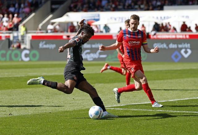 Soccer Football - Bundesliga - 1. FC Heidenheim v Bayern Munich - Voith-Arena, Heidenheim, Germany - April 19, 2025 Bayern Munich's Kingsley Coman scores their third goal REUTERS/Heiko Becker