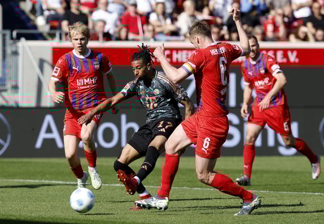 Soccer Football - Bundesliga - 1. FC Heidenheim v Bayern Munich - Voith-Arena, Heidenheim, Germany - April 19, 2025 Bayern Munich's Michael Olise shoots at goal REUTERS/Heiko Becker
