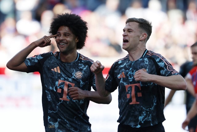 Soccer Football - Bundesliga - 1. FC Heidenheim v Bayern Munich - Voith-Arena, Heidenheim, Germany - April 19, 2025 Bayern Munich's Joshua Kimmich celebrates scoring their fourth goal with Serge Gnabry REUTERS/Heiko Becker